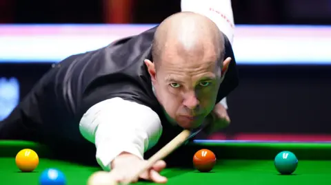 PA Media Barry Hawkins in his match with Judd Trump on day nine of the Victorian Plumbing UK Championship Snooker Championship at the York Barbican.