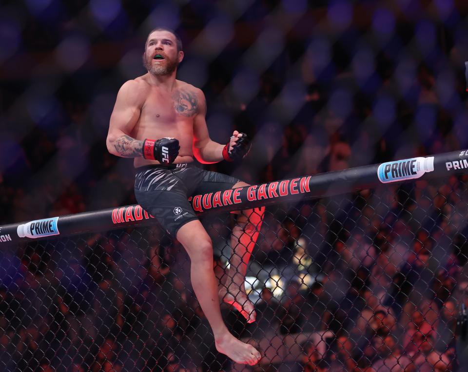 Nov 16, 2024; New York, NY, USA; Jim Miller (red gloves) reacts after defeating Damon Jackson (blue gloves) in the lightweight bout during UFC 309 at Madison Square Garden. Mandatory Credit: Brad Penner-Imagn Images