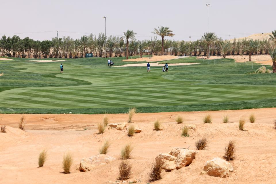 Golfers walk to their next hole on the grounds at the Riyadh Golf Club during the first round of the Golf Saudi Open 2024 Asian Tour in Riyadh.