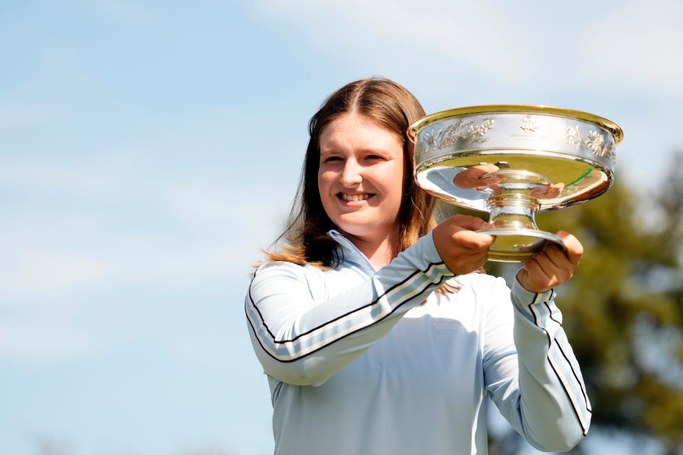 Lottie Woad holds the winner's trophy after winning the Augusta National Women's Amateur golf tournament at Augusta National Golf Club. Mandatory Credit: Rob Schumacher-USA TODAY Sports