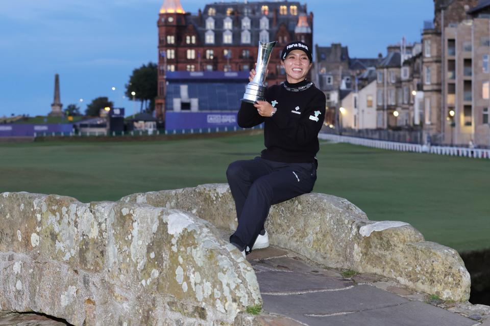 Lydia Ko poses for photos with the trophy on Swilcan Bridge after winning the 2024 AIG Women's Open on day four at St Andrews. Picture date: Sunday August 25, 2024.