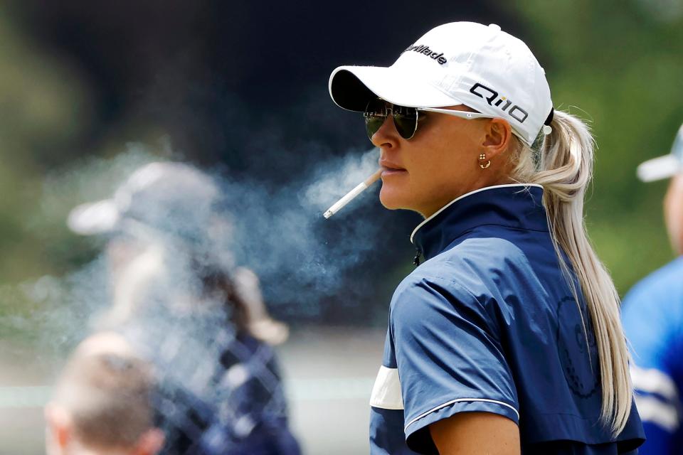 Charley Hull smokes a cigarette on the ninth tee during the first round of the 2024 U.S. Women's Open at Lancaster Country Club in Lancaster, Pennsylvania.