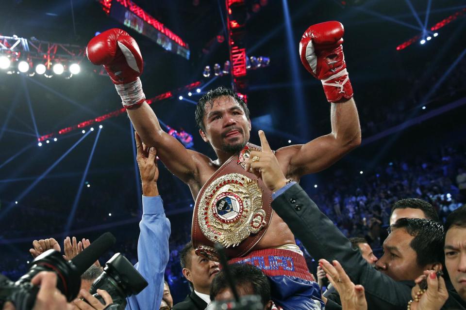 Manny Pacquiao celebrates after defeating Brandon Rios in a WBO welterweight title fight in Macao.