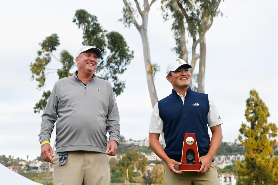 Hiroshi Tai of the Georgia Tech Yellow Jackets celebrates his individual championship with head coach Bruce Heppler.