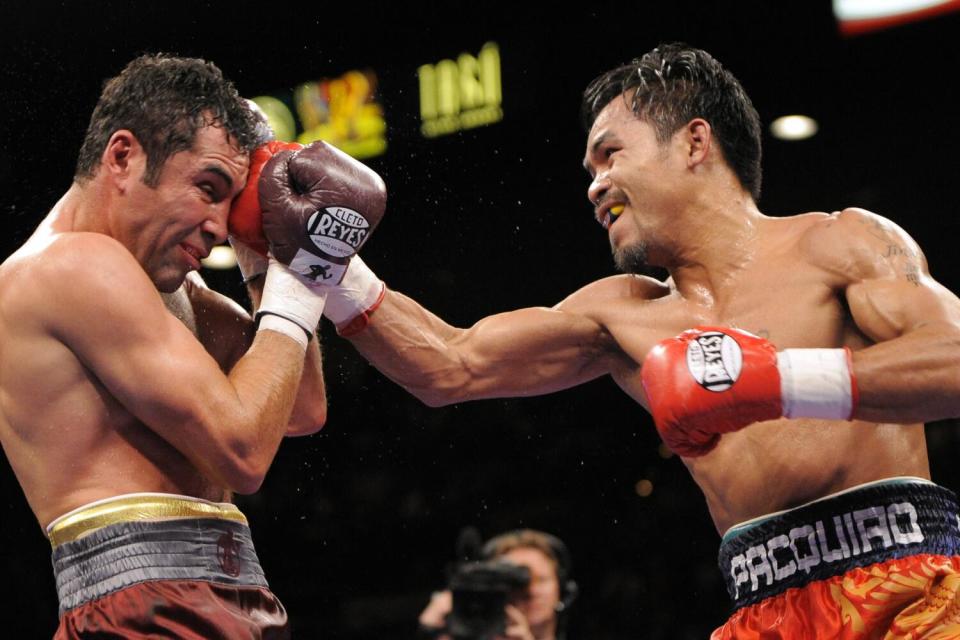 WBC lightweight champion Manny Pacquiao, right, punches Oscar De La Hoya during their welterweight bout in Las Vegas.