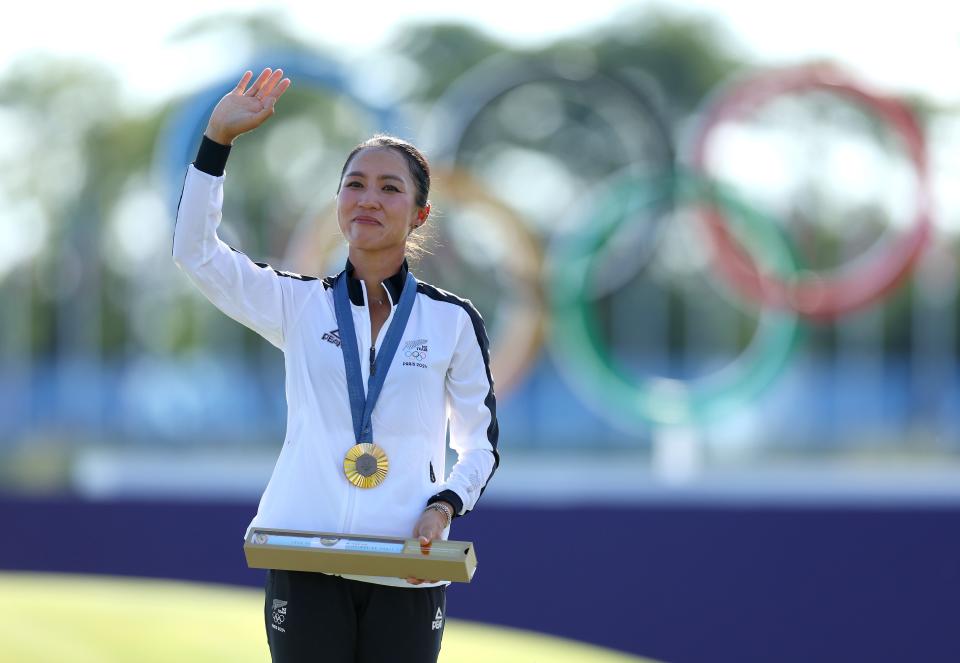 Gold medalist Lydia Ko celebrates on the podium during the Women's Individual Stroke Play Medal Ceremony on day fifteen of the Olympic Games Paris 2024 at Le Golf National on August 10, 2024 in Paris, France.