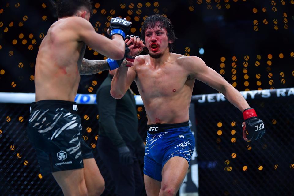 Jan 18, 2025; Inglewood, California, USA; Ricky Turcios (red gloves) fights Benardo Sopaj (blue gloves) during UFC 311 at Intuit Dome. Mandatory Credit: Gary A. Vasquez-Imagn Images