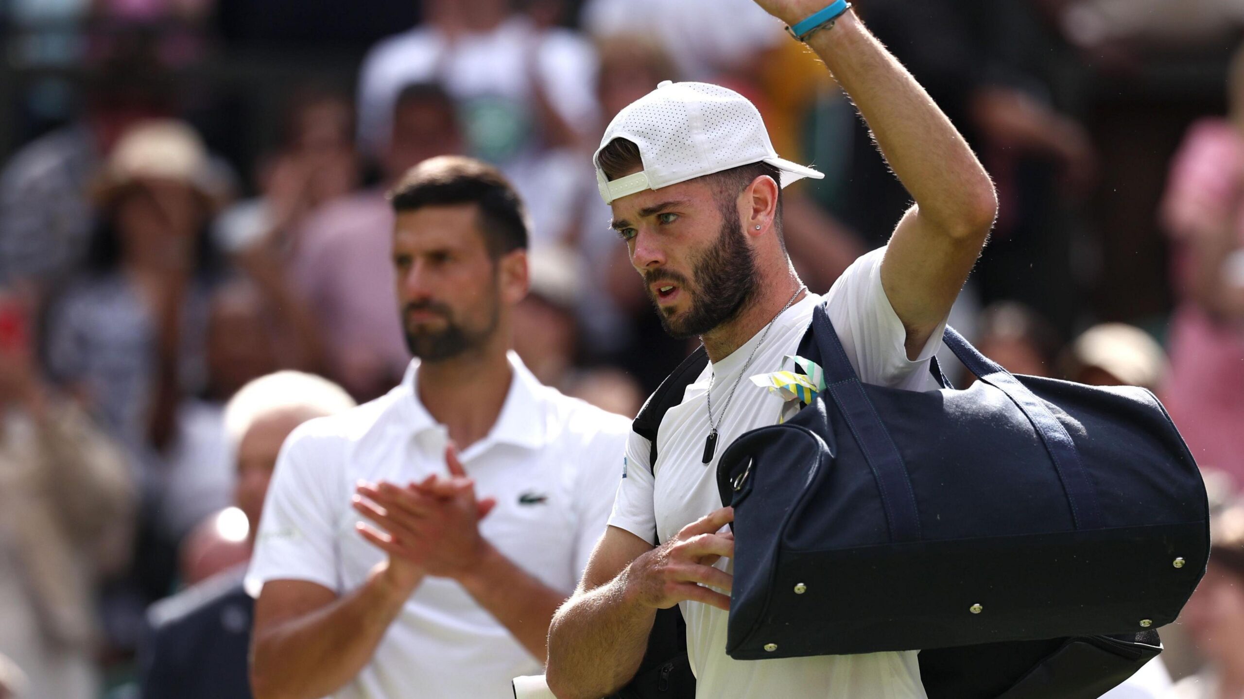 Jacob Fearnley is applauded off court by Novak Djokovic at Wimbledon