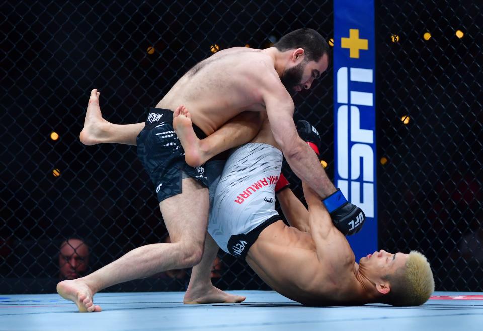 Jan 18, 2025; Inglewood, California, USA; Rinya Nakamura (red gloves) fights Muin Gafurov (blue gloves) during UFC 311 at Intuit Dome. Mandatory Credit: Gary A. Vasquez-Imagn Images