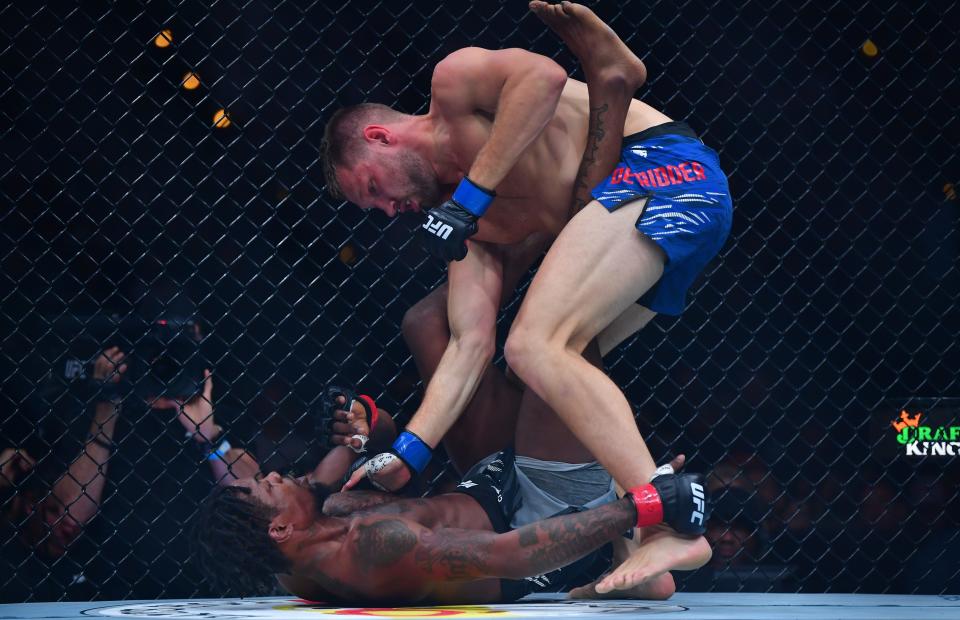 Jan 18, 2025; Inglewood, California, USA; Kevin Holland (red gloves) fights Reinier de Ridder (blue gloves) during UFC 311 at Intuit Dome. Mandatory Credit: Gary A. Vasquez-Imagn Images