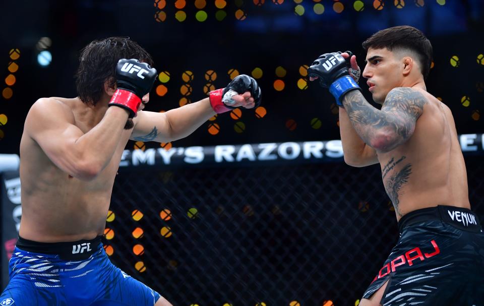 Jan 18, 2025; Inglewood, California, USA; Ricky Turcios (red gloves) fights Benardo Sopaj (blue gloves) during UFC 311 at Intuit Dome. Mandatory Credit: Gary A. Vasquez-Imagn Images