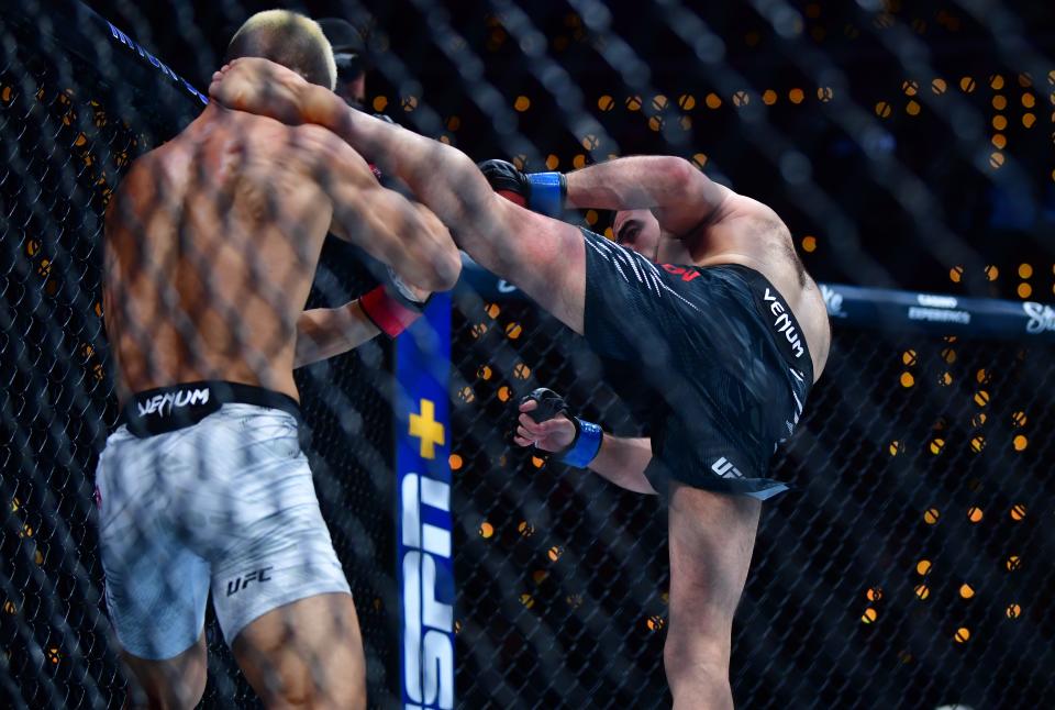 Jan 18, 2025; Inglewood, California, USA; Rinya Nakamura (red gloves) fights Muin Gafurov (blue gloves) during UFC 311 at Intuit Dome. Mandatory Credit: Gary A. Vasquez-Imagn Images