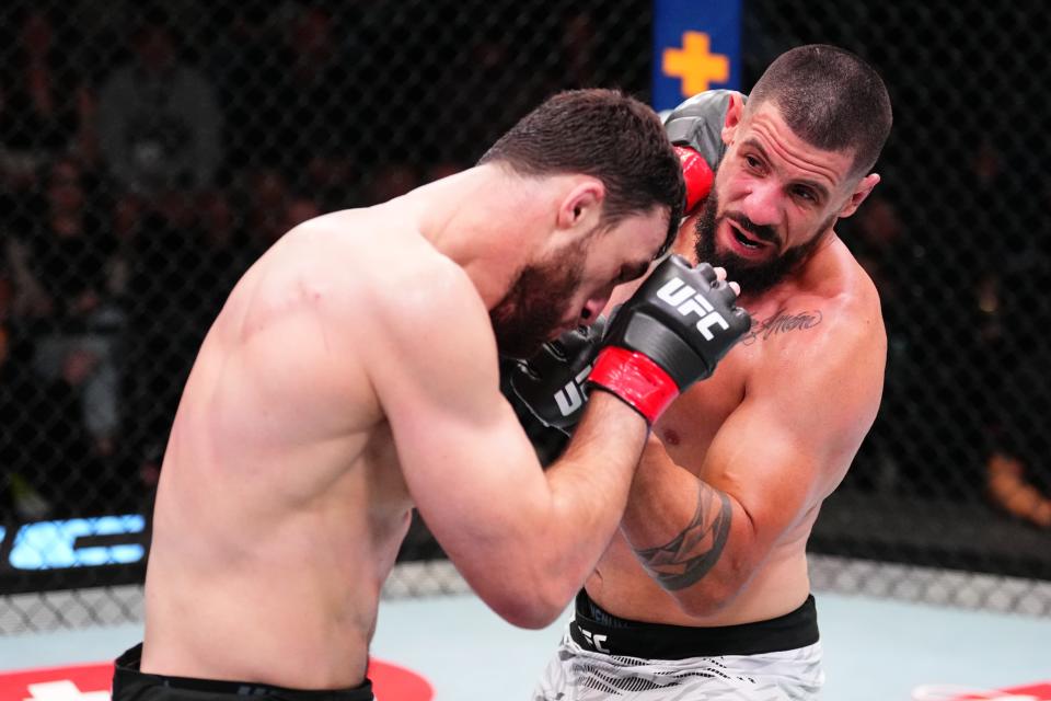 LAS VEGAS, NEVADA - JANUARY 11: (R-L) Bruno Lopes of Brazil punches Magomed Gadzhiyasulov of Russia in a light heavyweight fight during the UFC Fight Night event at UFC APEX on January 11, 2025 in Las Vegas, Nevada. (Photo by Chris Unger/Zuffa LLC via Getty Images)