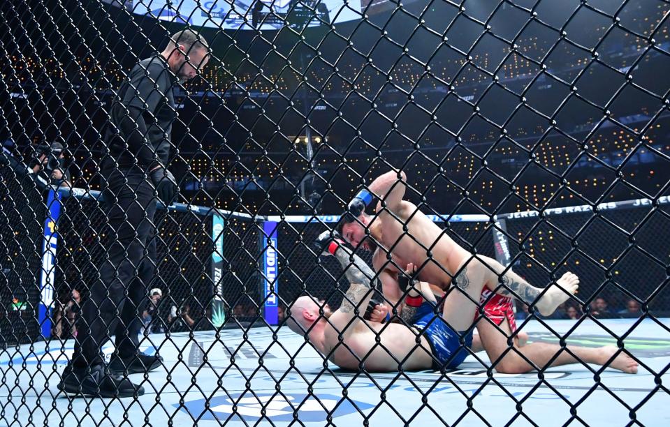 Jan 18, 2025; Inglewood, California, USA; Zachary Reese (red gloves) fights Azamat Bekoev (blue gloves) during UFC 311 at Intuit Dome. Mandatory Credit: Gary A. Vasquez-Imagn Images