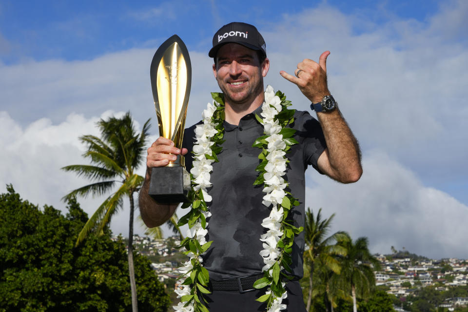 Nick Taylor poses with his trophy after winning the Sony Open at Waialae Country Club in Honolulu. (AP Photo/Matt York)