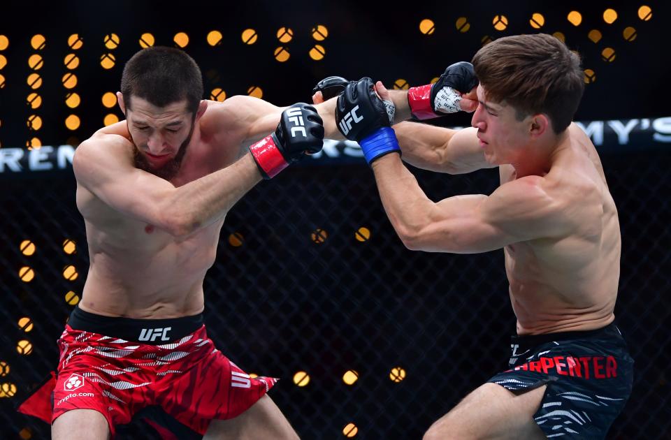 Jan 18, 2025; Inglewood, California, USA; Tagir Ulanbekov (red gloves) fights Clayton Carpenter (blue gloves) during UFC 311 at Intuit Dome. Mandatory Credit: Gary A. Vasquez-Imagn Images