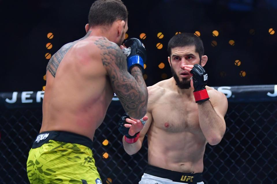 Jan 18, 2025; Inglewood, California, USA; Islam Makhachev (red gloves) fights Renato Moicano (blue gloves) in a lightweight title fight during UFC 311 at Intuit Dome. Mandatory Credit: Gary A. Vasquez-Imagn Images