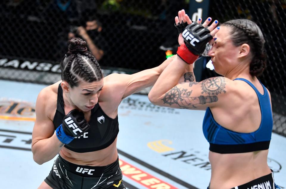 LAS VEGAS, NEVADA - APRIL 10: (L-R) Mackenzie Dern punches Nina Nunes in a strawweight fight during the UFC Fight Night event at UFC APEX on April 10, 2021 in Las Vegas, Nevada. (Photo by Chris Unger/Zuffa LLC)