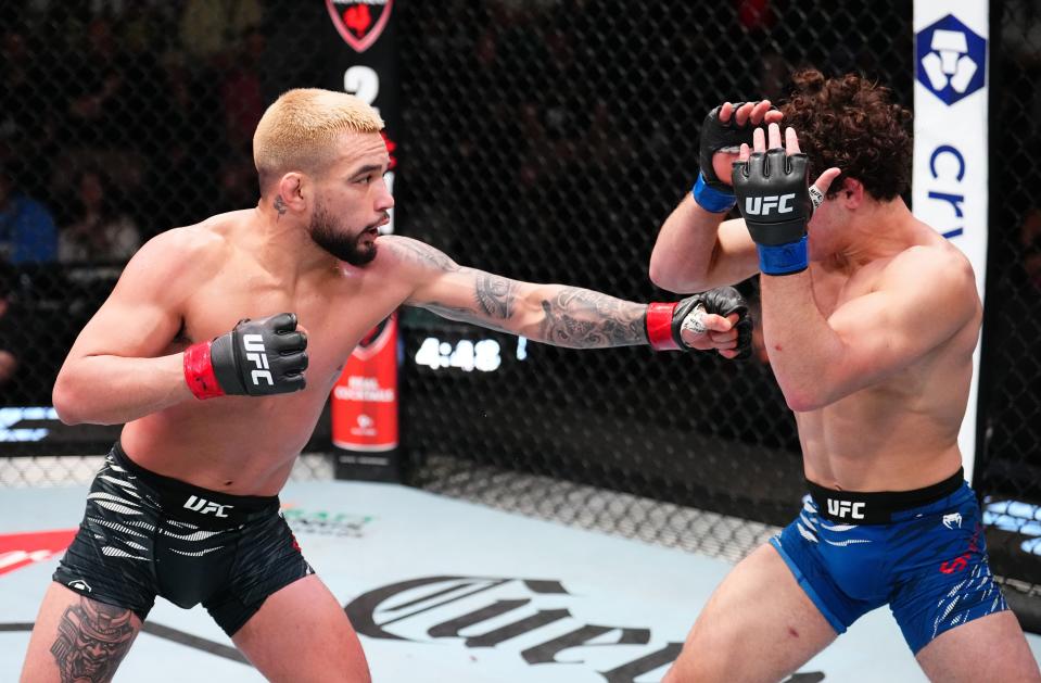 LAS VEGAS, NEVADA - JANUARY 11: (L-R) Christian Rodriguez punches Austin Bashi in a featherweight fight during the UFC Fight Night event at UFC APEX on January 11, 2025 in Las Vegas, Nevada. (Photo by Chris Unger/Zuffa LLC via Getty Images)