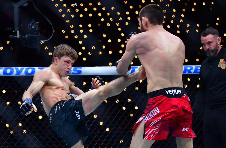 Jan 18, 2025; Inglewood, California, USA; Tagir Ulanbekov (red gloves) fights Clayton Carpenter (blue gloves) during UFC 311 at Intuit Dome. Mandatory Credit: Gary A. Vasquez-Imagn Images