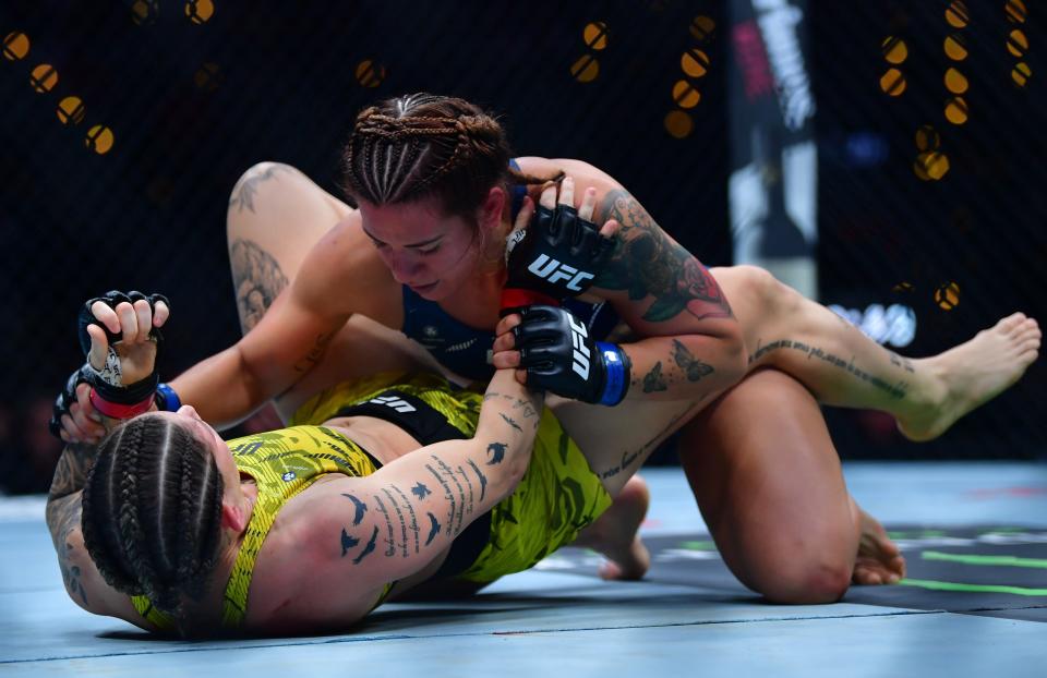 Jan 18, 2025; Inglewood, California, USA; Karol Rosa (red gloves) fights Ailin Perez (blue gloves) during UFC 311 at Intuit Dome. Mandatory Credit: Gary A. Vasquez-Imagn Images