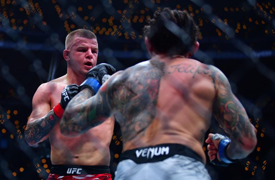 Jan 18, 2025; Inglewood, California, USA; Grant Dawson (red gloves) fights Diego Ferreira (blue gloves) during UFC 311 at Intuit Dome. Mandatory Credit: Gary A. Vasquez-Imagn Images