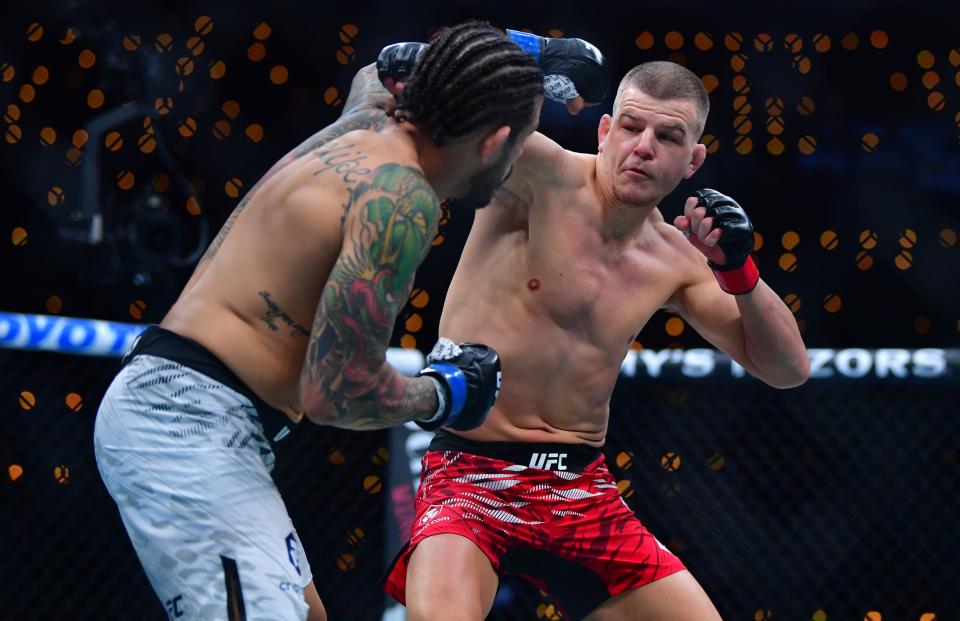 Jan 18, 2025; Inglewood, California, USA; Grant Dawson (red gloves) fights Diego Ferreira (blue gloves) during UFC 311 at Intuit Dome. Mandatory Credit: Gary A. Vasquez-Imagn Images