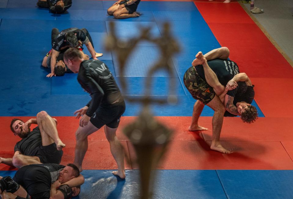 Austin Bashi, right, of West Bloomfield, continues a hold on Karlo Bashi, as he stands while they train in grappling with others at Warrior Way Martial Arts Allnc in Commerce Township on Friday, December 20, 2024. Bashi is about to make his UFC debut in early January in Las Vegas and is regarded as the top UFC prospect in the country.