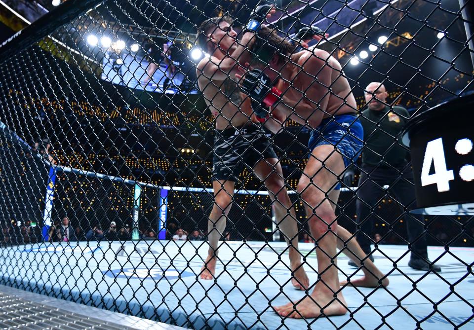 Jan 18, 2025; Inglewood, California, USA; Ricky Turcios (red gloves) fights Benardo Sopaj (blue gloves) during UFC 311 at Intuit Dome. Mandatory Credit: Gary A. Vasquez-Imagn Images