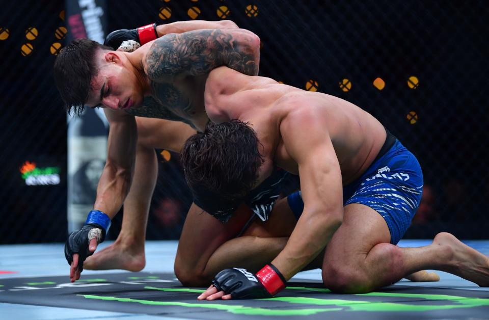 Jan 18, 2025; Inglewood, California, USA; Ricky Turcios (red gloves) fights Benardo Sopaj (blue gloves) during UFC 311 at Intuit Dome. Mandatory Credit: Gary A. Vasquez-Imagn Images