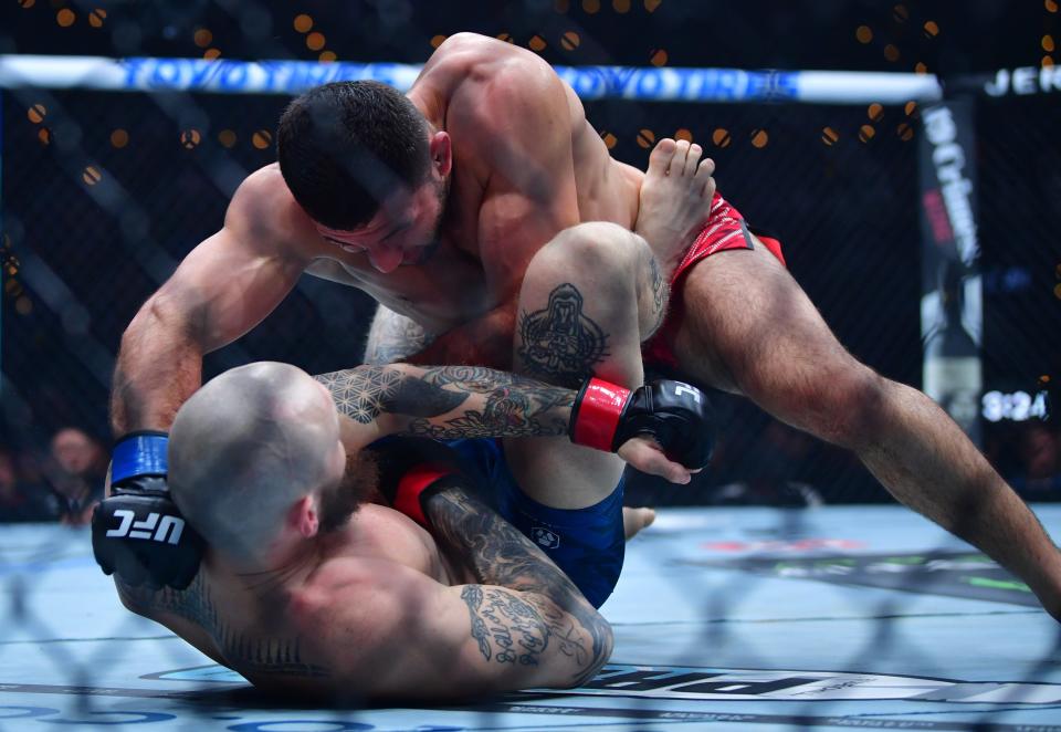 Jan 18, 2025; Inglewood, California, USA; Zachary Reese (red gloves) fights Azamat Bekoev (blue gloves) during UFC 311 at Intuit Dome. Mandatory Credit: Gary A. Vasquez-Imagn Images