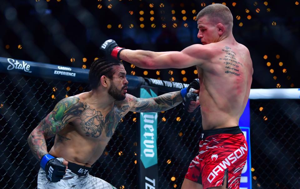 Jan 18, 2025; Inglewood, California, USA; Grant Dawson (red gloves) fights Diego Ferreira (blue gloves) during UFC 311 at Intuit Dome. Mandatory Credit: Gary A. Vasquez-Imagn Images