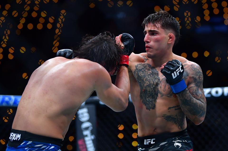 Jan 18, 2025; Inglewood, California, USA; Ricky Turcios (red gloves) fights Benardo Sopaj (blue gloves) during UFC 311 at Intuit Dome. Mandatory Credit: Gary A. Vasquez-Imagn Images