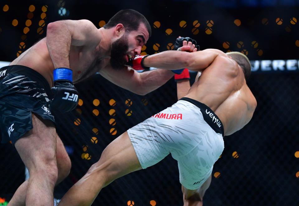 Jan 18, 2025; Inglewood, California, USA; Rinya Nakamura (red gloves) fights Muin Gafurov (blue gloves) during UFC 311 at Intuit Dome. Mandatory Credit: Gary A. Vasquez-Imagn Images