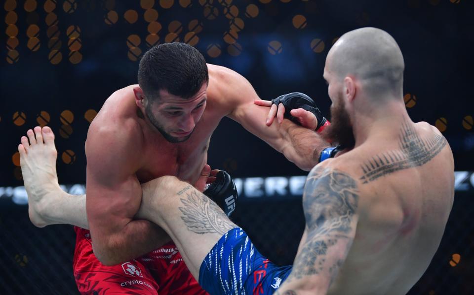 Jan 18, 2025; Inglewood, California, USA; Zachary Reese (red gloves) fights Azamat Bekoev (blue gloves) during UFC 311 at Intuit Dome. Mandatory Credit: Gary A. Vasquez-Imagn Images