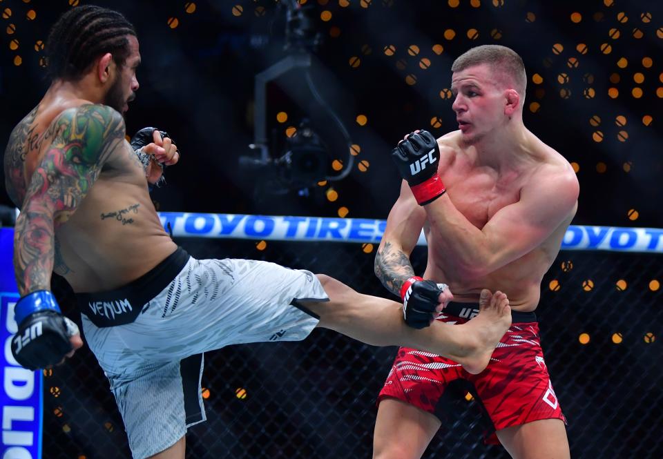 Jan 18, 2025; Inglewood, California, USA; Grant Dawson (red gloves) fights Diego Ferreira (blue gloves) during UFC 311 at Intuit Dome. Mandatory Credit: Gary A. Vasquez-Imagn Images