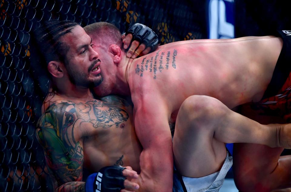 Jan 18, 2025; Inglewood, California, USA; Grant Dawson (red gloves) fights Diego Ferreira (blue gloves) during UFC 311 at Intuit Dome. Mandatory Credit: Gary A. Vasquez-Imagn Images