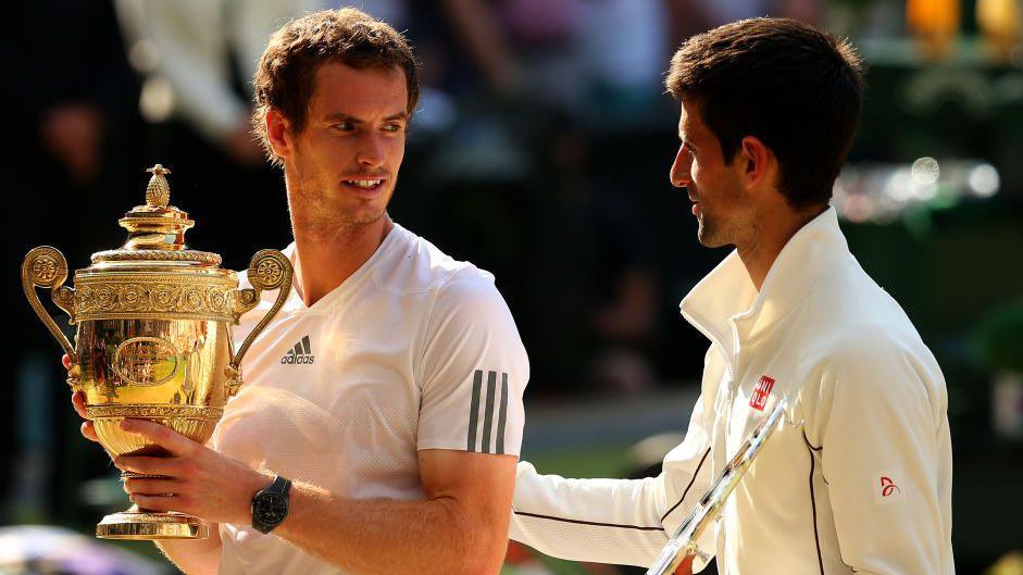 Andy Murray is congratulated by Novak Djokovic after receiving the Wimbledon trophy in 2013