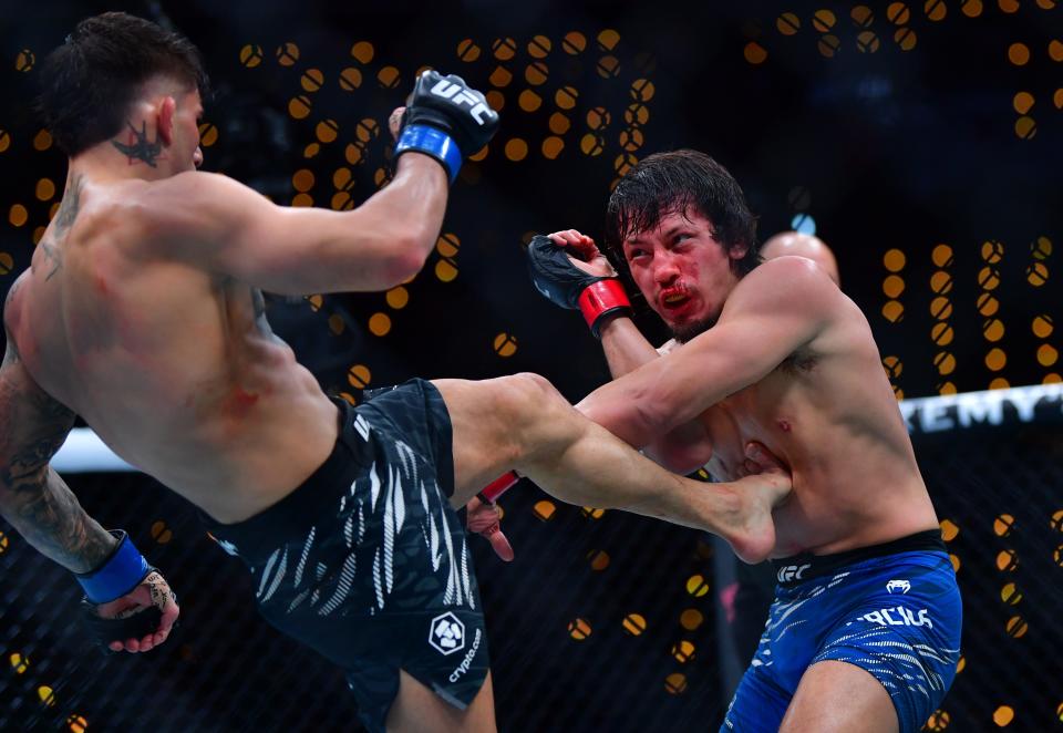 Jan 18, 2025; Inglewood, California, USA; Ricky Turcios (red gloves) fights Benardo Sopaj (blue gloves) during UFC 311 at Intuit Dome. Mandatory Credit: Gary A. Vasquez-Imagn Images