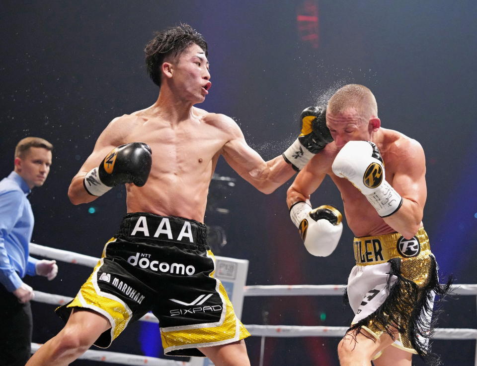 Naoya Inoue of Japan throws a punch at Paul Butler of Britain during their bantamweight title unification boxing match of WBA, WBC, IBF and WBO in Tokyo, Japan, December 13, 2022, in this photo released by Kyodo. Kyodo via REUTERS ATTENTION EDITORS - THIS IMAGE WAS PROVIDED BY A THIRD PARTY. MANDATORY CREDIT. JAPAN OUT. NO COMMERCIAL OR EDITORIAL SALES IN JAPAN