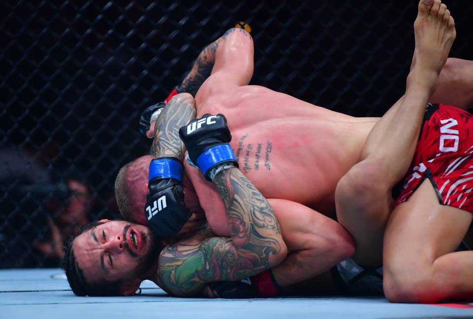 Jan 18, 2025; Inglewood, California, USA; Grant Dawson (red gloves) fights Diego Ferreira (blue gloves) during UFC 311 at Intuit Dome. Mandatory Credit: Gary A. Vasquez-Imagn Images