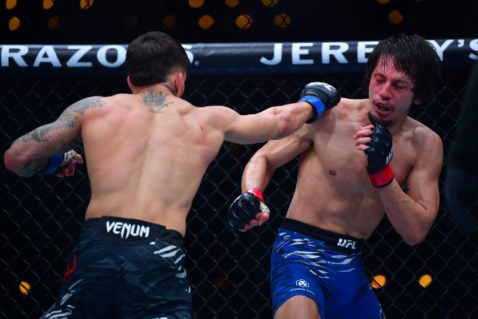 Jan 18, 2025; Inglewood, California, USA; Ricky Turcios (red gloves) fights Benardo Sopaj (blue gloves) during UFC 311 at Intuit Dome. Mandatory Credit: Gary A. Vasquez-Imagn Images