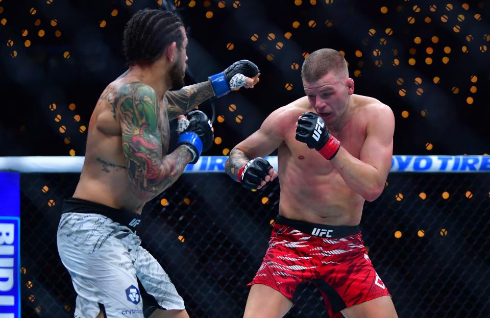 Jan 18, 2025; Inglewood, California, USA; Grant Dawson (red gloves) fights Diego Ferreira (blue gloves) during UFC 311 at Intuit Dome. Mandatory Credit: Gary A. Vasquez-Imagn Images