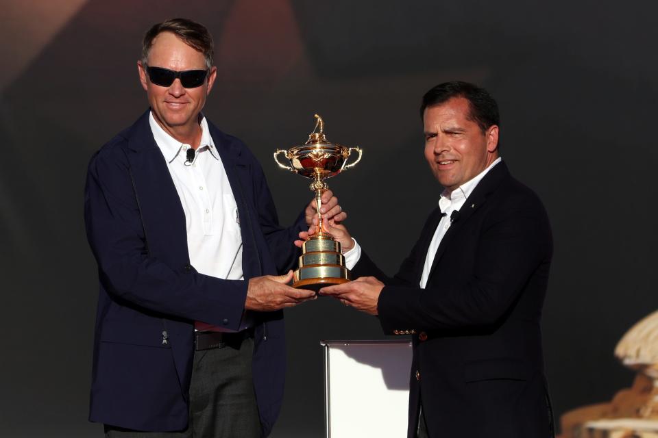 PGA of America president Derek Sprague presents the Ryder Cup to Team USA captain Davis Love III during the closing ceremonies after the single matches in 41st Ryder Cup at Hazeltine National Golf Club.