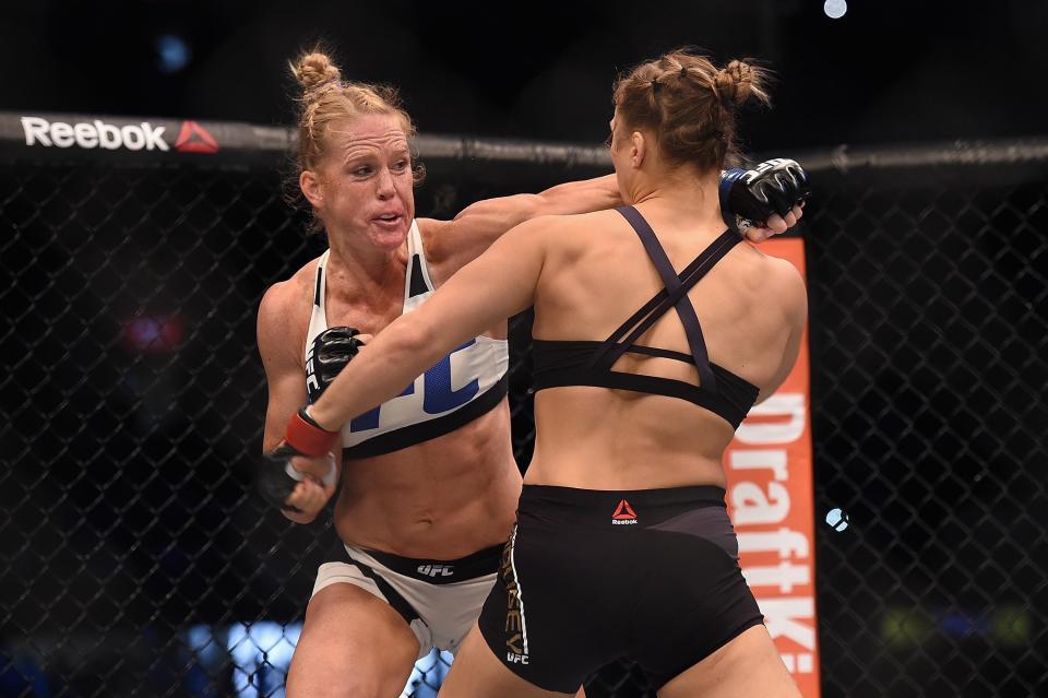 Nov 15, 2015; Melbourne, Australia; Ronda Rousey (red gloves) competes against Holly Holm (blue gloves) during UFC 193 at Etihad Stadium. Mandatory Credit: Matt Roberts-USA TODAY Sports