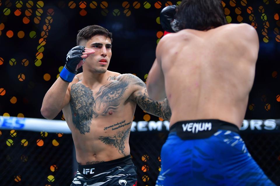 Jan 18, 2025; Inglewood, California, USA; Ricky Turcios (red gloves) fights Benardo Sopaj (blue gloves) during UFC 311 at Intuit Dome. Mandatory Credit: Gary A. Vasquez-Imagn Images