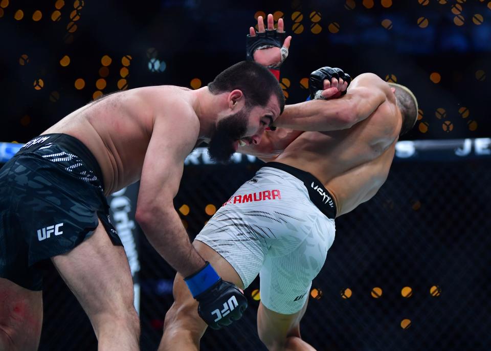 Jan 18, 2025; Inglewood, California, USA; Rinya Nakamura (red gloves) fights Muin Gafurov (blue gloves) during UFC 311 at Intuit Dome. Mandatory Credit: Gary A. Vasquez-Imagn Images