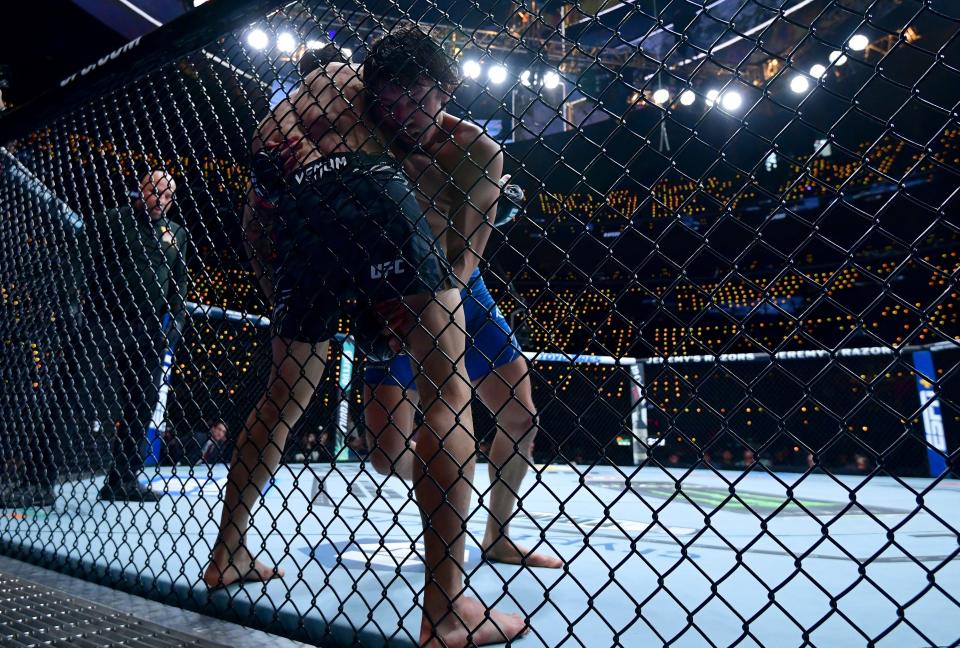 Jan 18, 2025; Inglewood, California, USA; Ricky Turcios (red gloves) fights Benardo Sopaj (blue gloves) during UFC 311 at Intuit Dome. Mandatory Credit: Gary A. Vasquez-Imagn Images