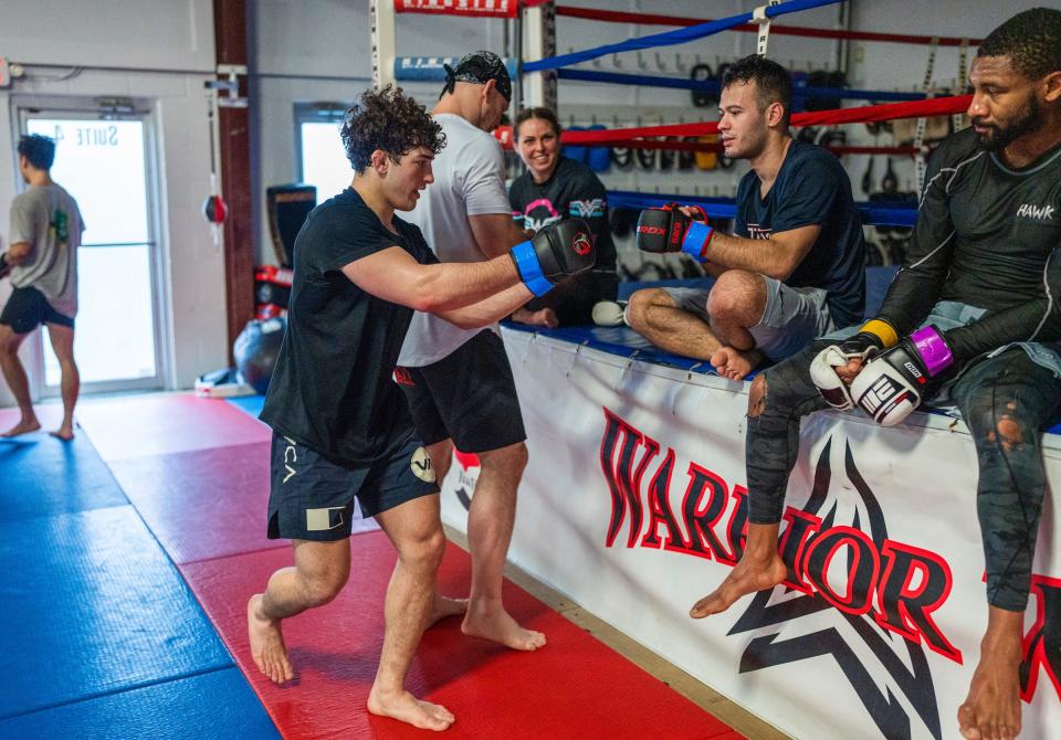 Austin Bashi, left, of West Bloomfield, walks around thanking other fighters after MMA training at Warrior Way Martial Arts Allnc in Commerce Township on Friday, December 20, 2024. Bashi is about to make his UFC debut in early January in Las Vegas and is regarded as the top UFC prospect in the country.