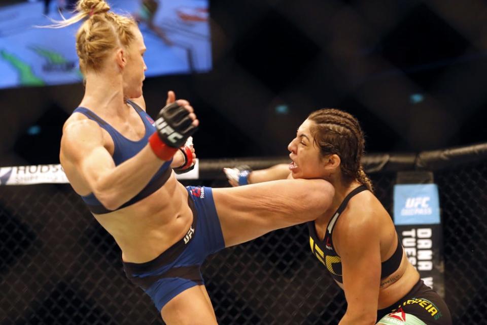 Jun 17, 2017; Singapore, Singapore;   Bethe Correia (blue gloves) competes against Holly Holm (red gloves) during UFC Fight Night at Singapore Indoor Stadium. Mandatory Credit: David G. McIntyre-USA TODAY Sports